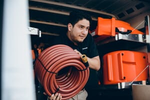 commercial restoration technician taking equipment out of van