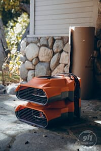 disaster restoration equipment on stoop of house