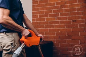 water damage restoration technician vacuuming water in office